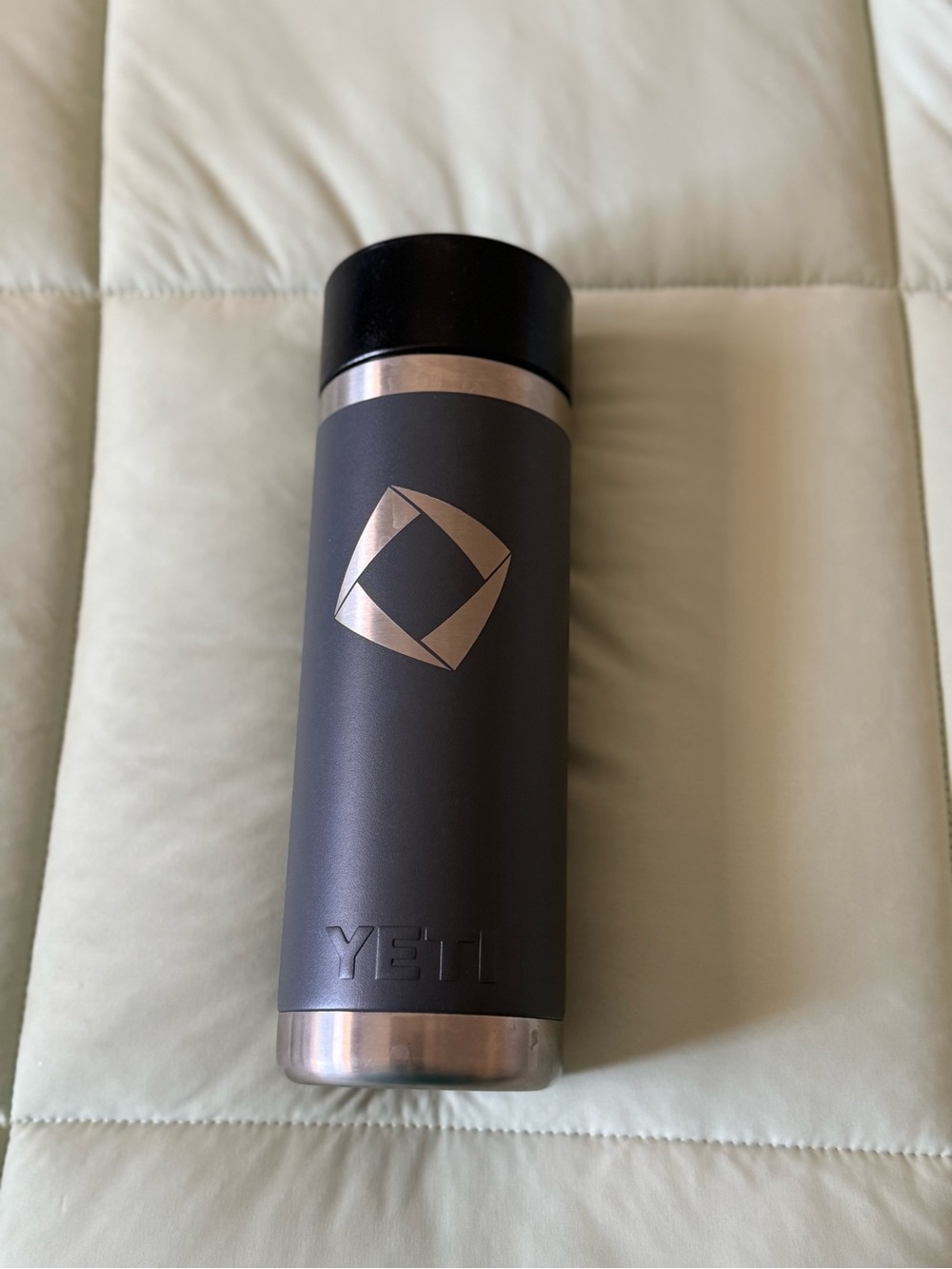 YETI Black and Silver Travel Bottle/ Rambler 18 oz Bottle in a charcoal